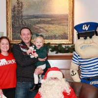 A family of three at the event with Santa & Louie.
